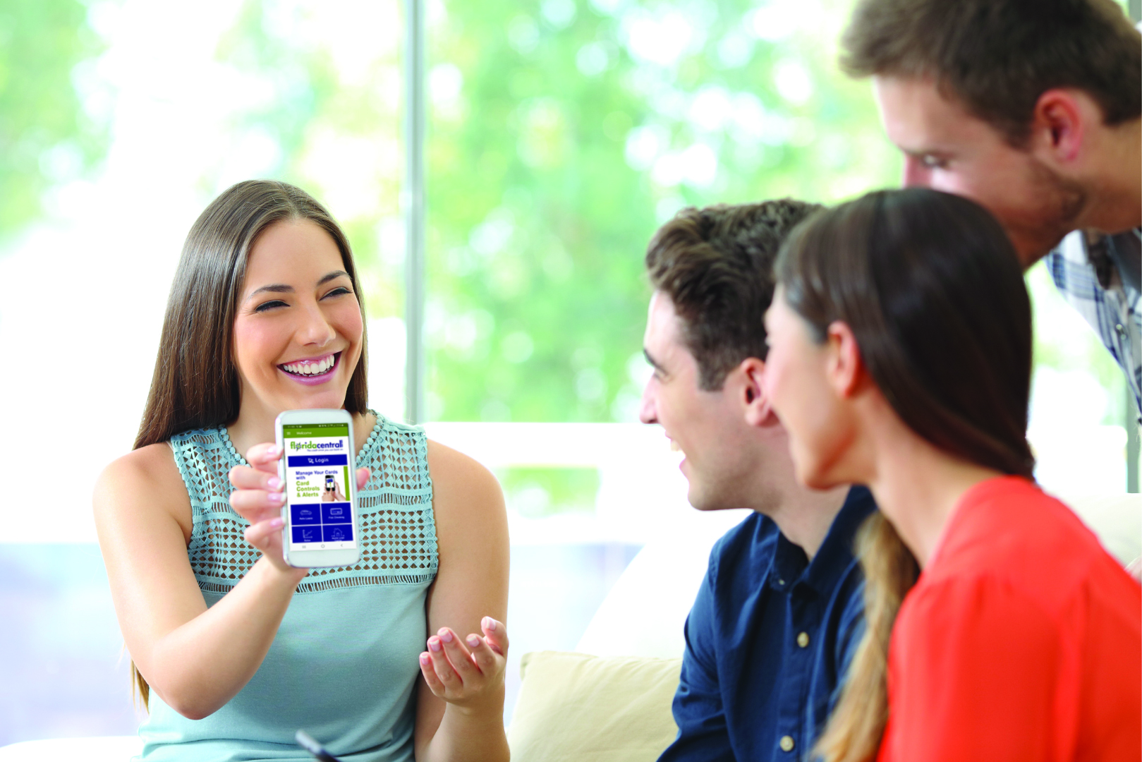 Woman show her friends floridacentral's Mobile Banking app